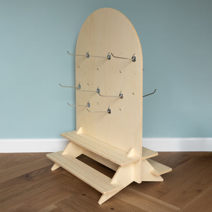 Curved Table Top Pegboard with Tiered Shelving and Retail Hooks