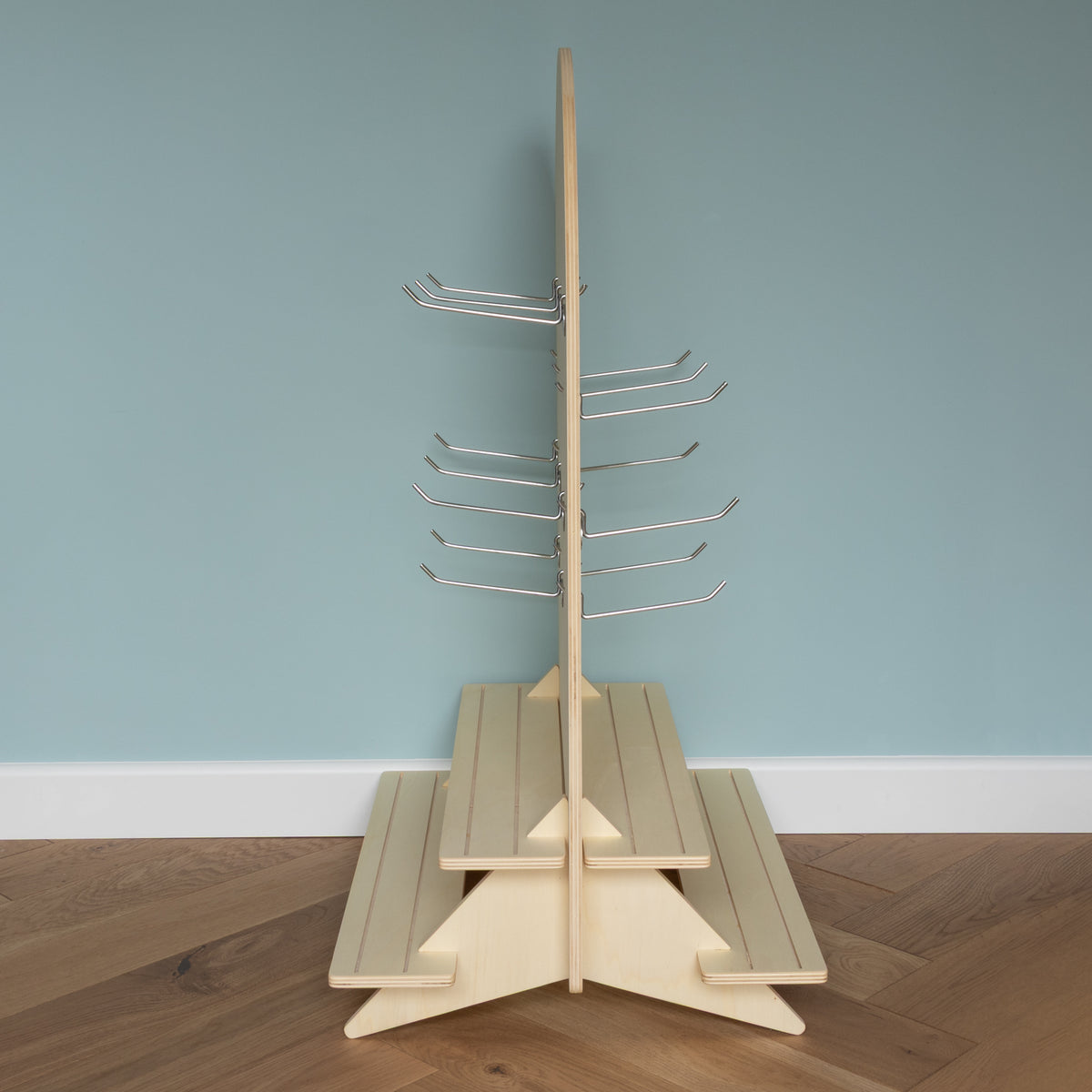 Curved Table Top Pegboard with Tiered Shelving and Retail Hooks